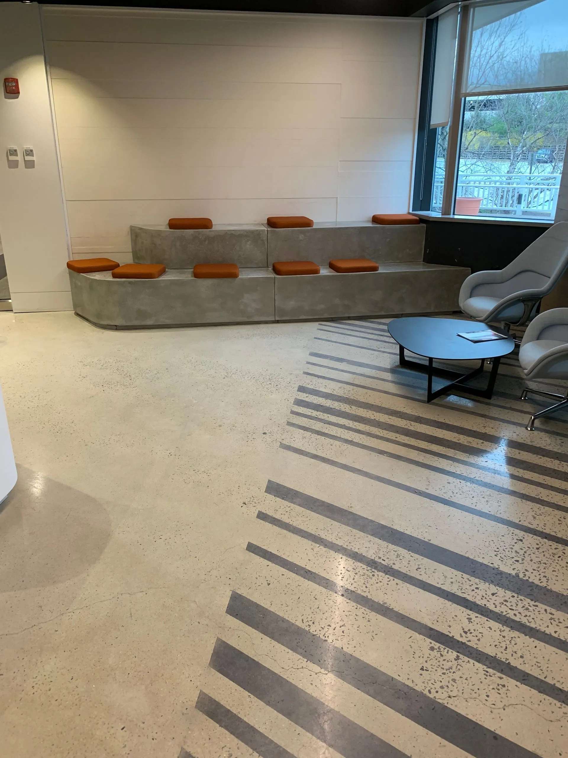 A living room with a polished concrete floor